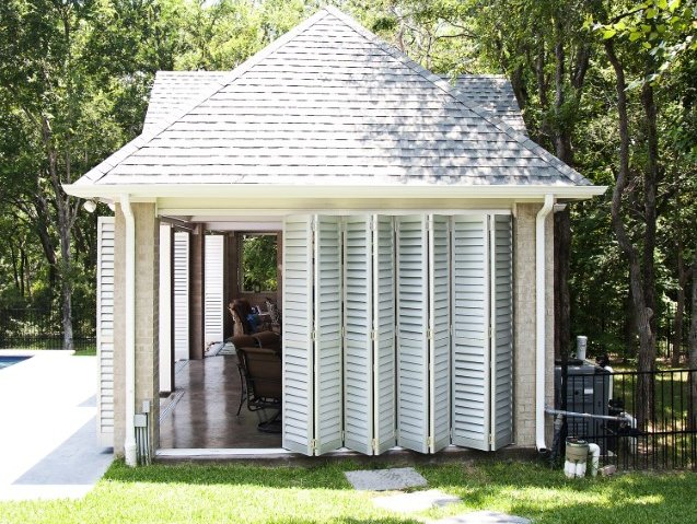 Accordion door shades in a pool house
